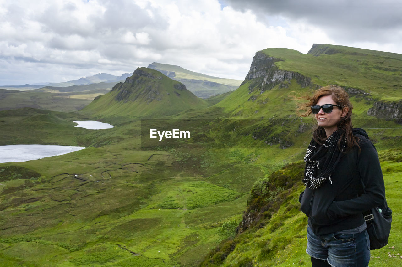 Woman looks out at the dramatic view in quiraing isle of skye scotland