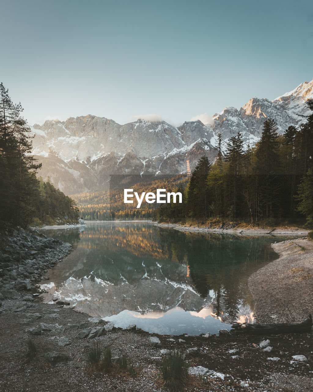 Scenic view of lake and mountains against clear sky