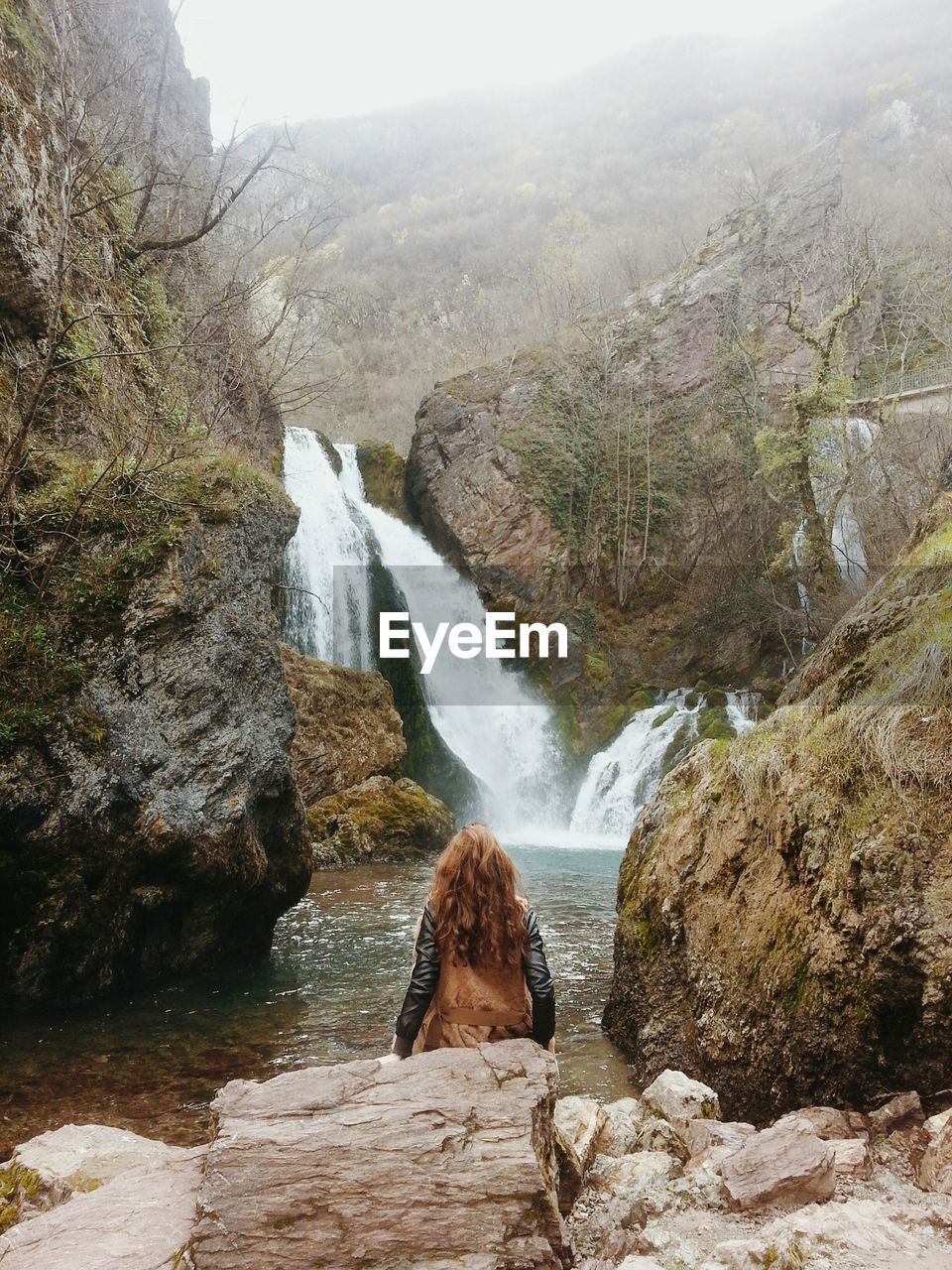 Scenic view of waterfall against sky