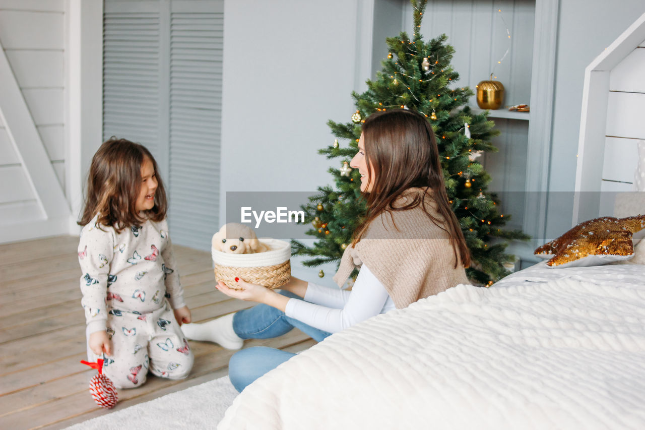 GIRL SITTING ON TOY AT HOME