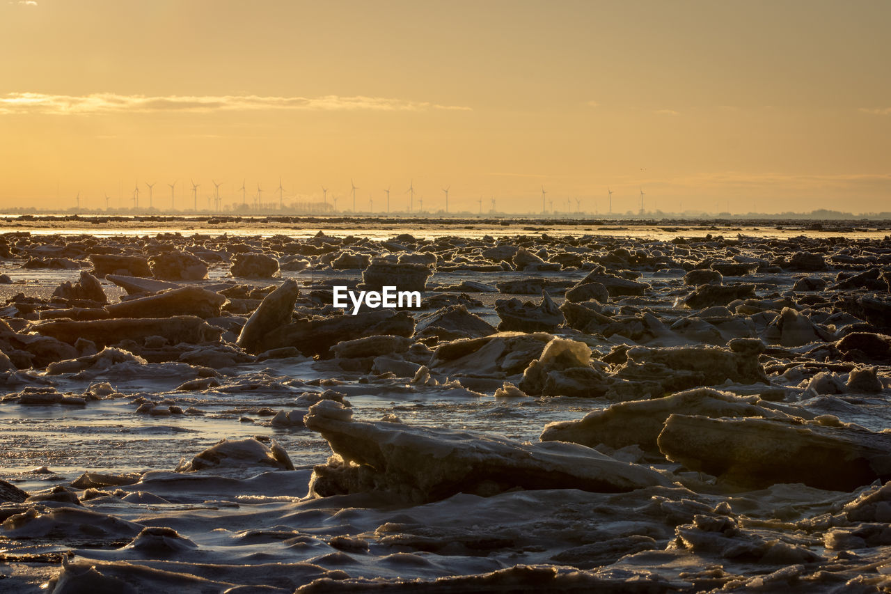 Aerial view of sea against sky during sunset