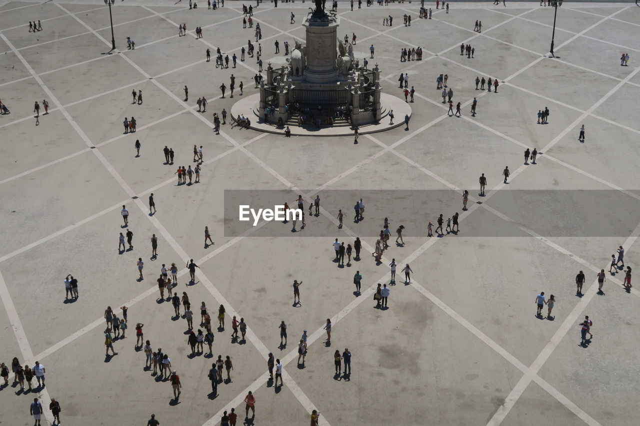 High angle view of people walking in city square