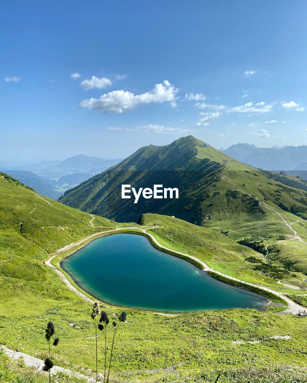 Scenic view of mountains with lake against sky