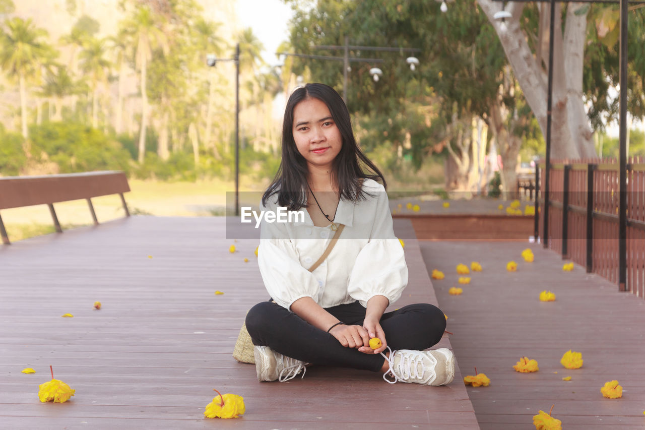 Portrait of young woman sitting outdoors