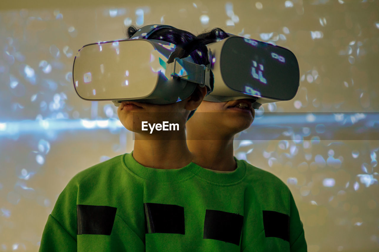 Young girl playing with virtual reality glasses, multiple exposure