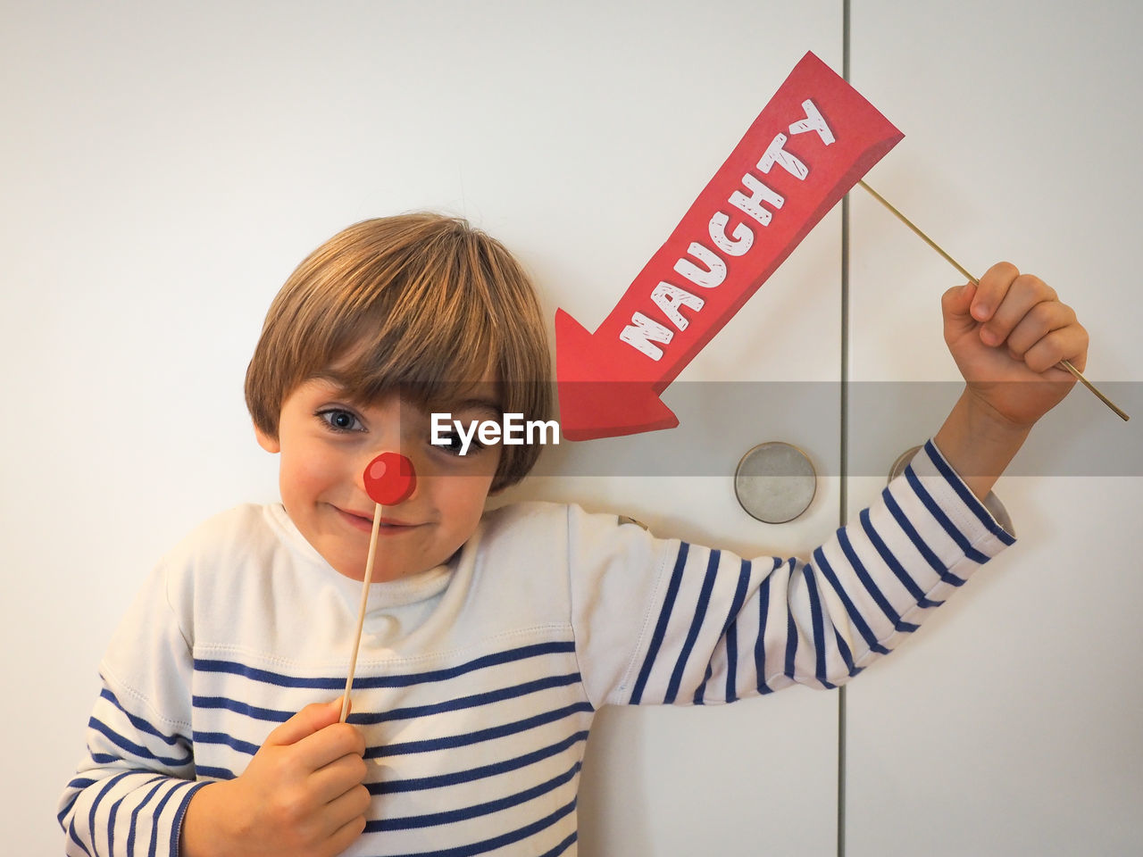 Close-up of girl holding arrow sign