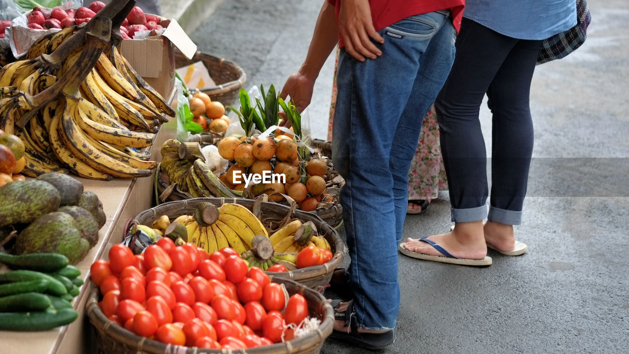 Low section of people standing in market