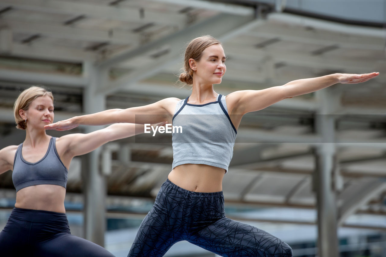 Two women exercising in city