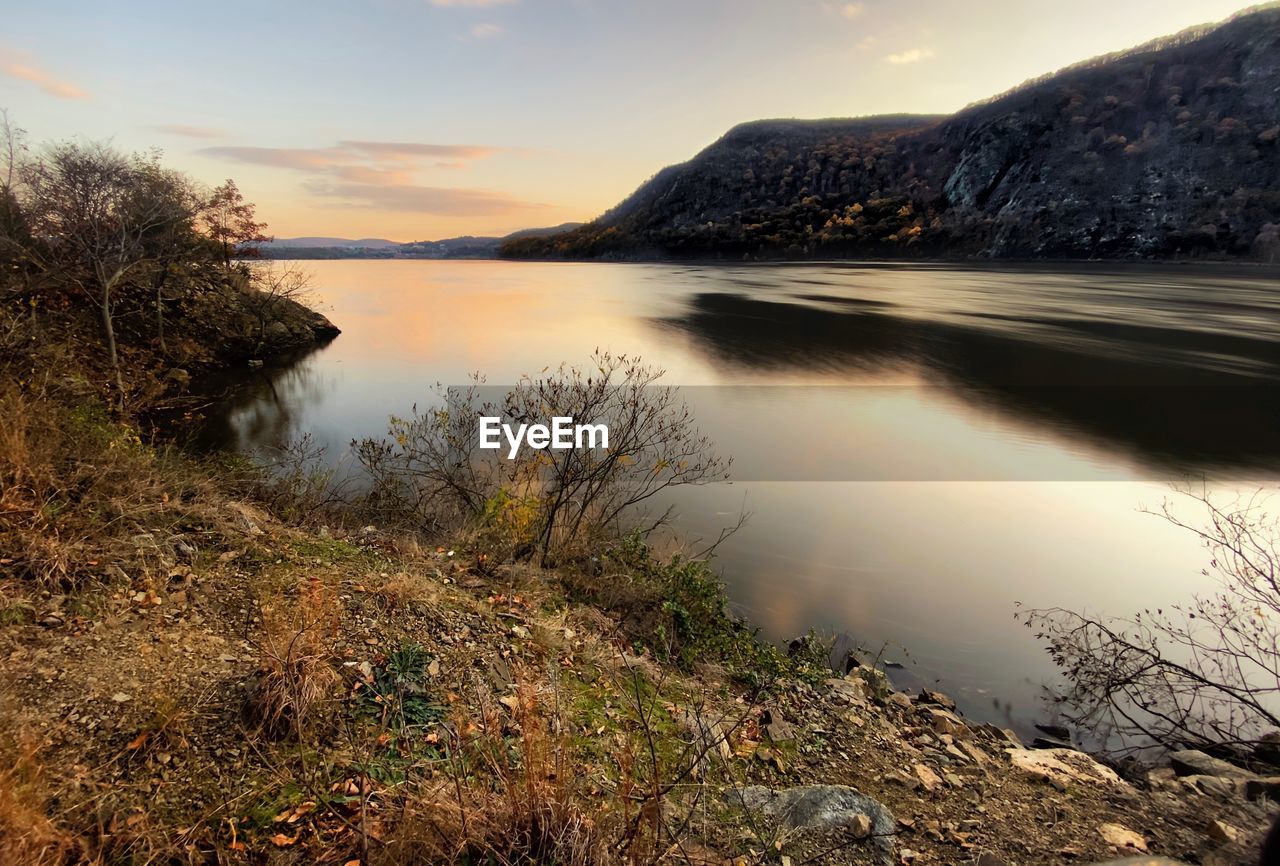 Scenic view of lake against sky during sunset