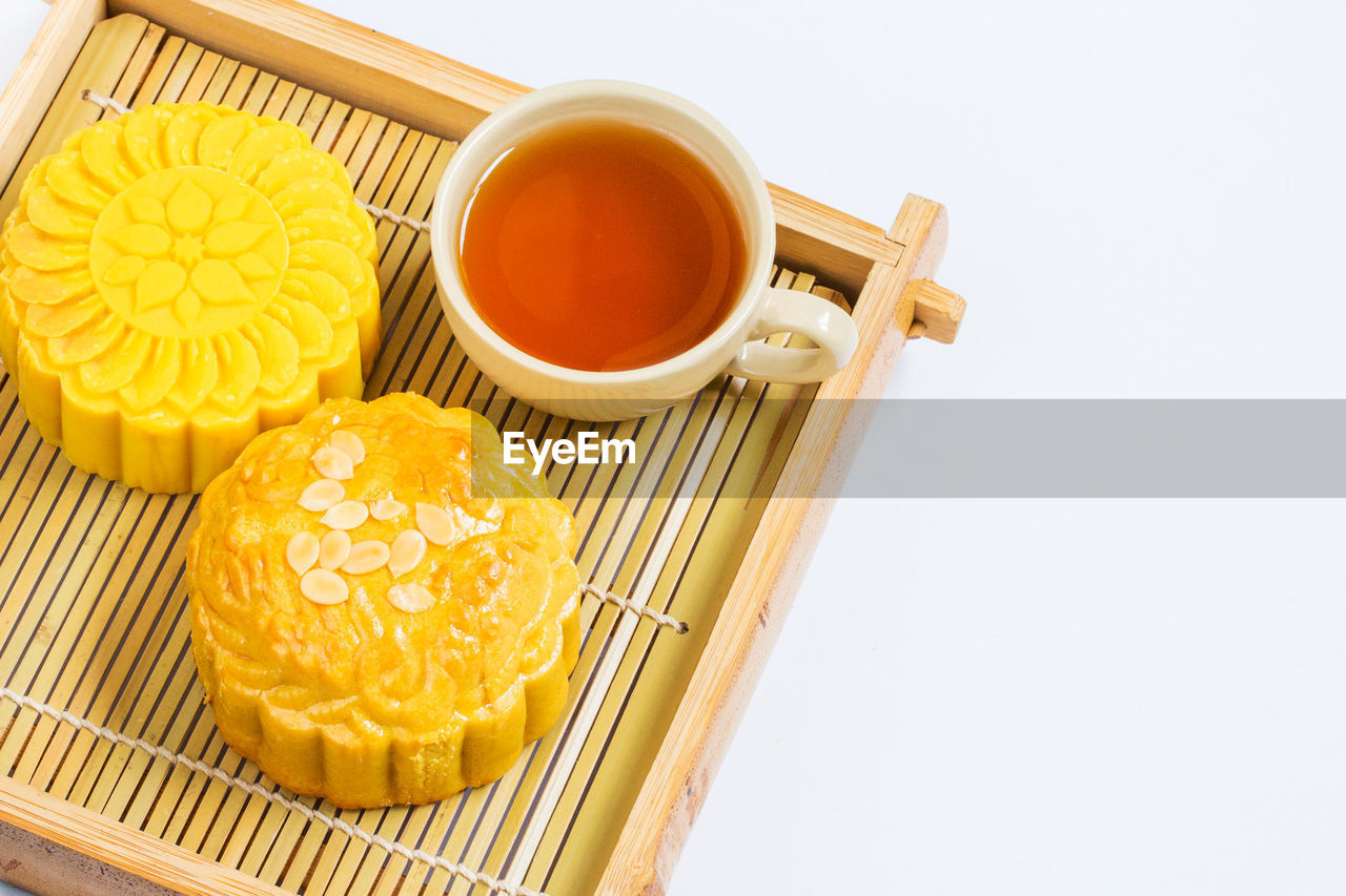 food and drink, food, yellow, studio shot, cup, freshness, tea, drink, no people, mug, asian food, tea cup, sweet food, wellbeing, produce, healthy eating, indoors, refreshment, hot drink, white background, container, fruit, snack, still life