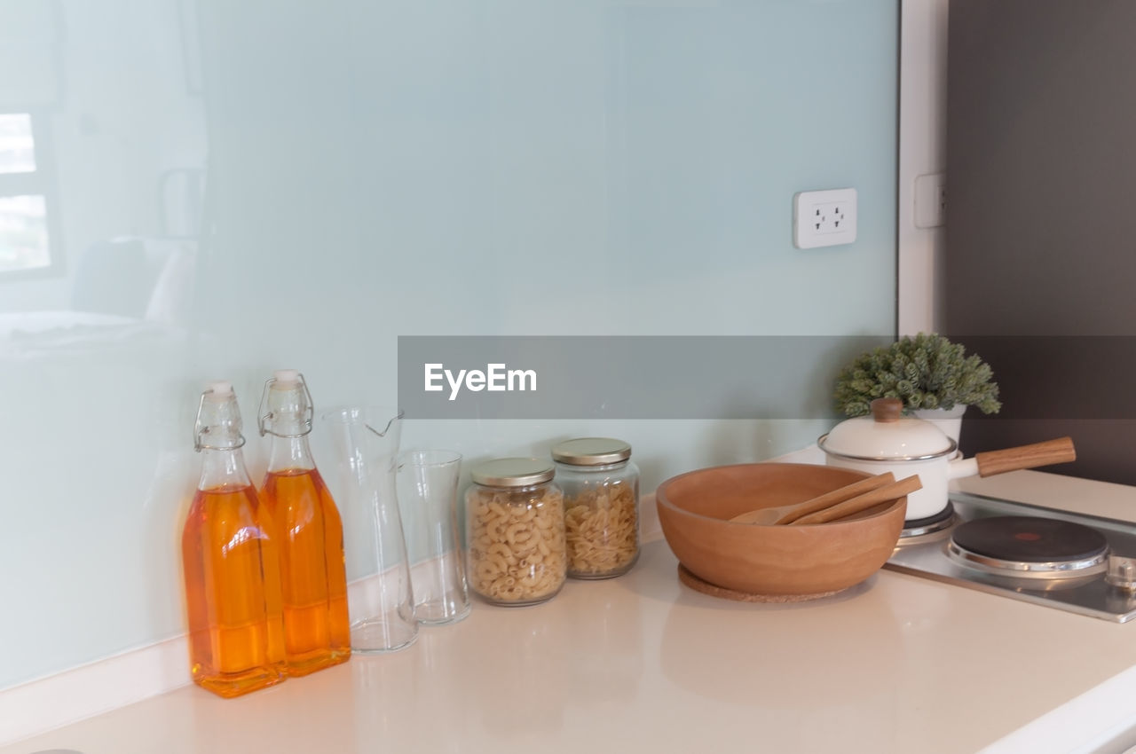 POTTED PLANT ON TABLE BY WALL AT HOME