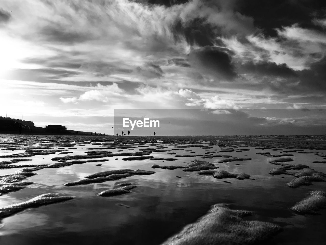 SURFACE LEVEL OF BEACH AGAINST SKY