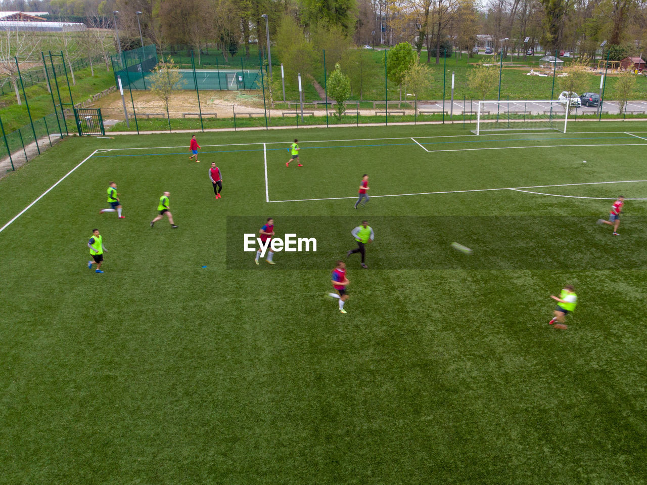 GROUP OF PEOPLE PLAYING SOCCER FIELD