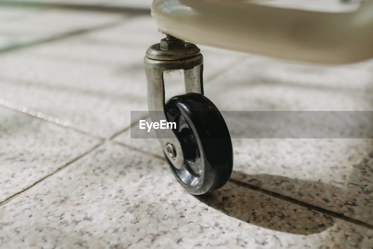 wheel, white, no people, bicycle, iron, focus on foreground, close-up, flooring, vehicle, day