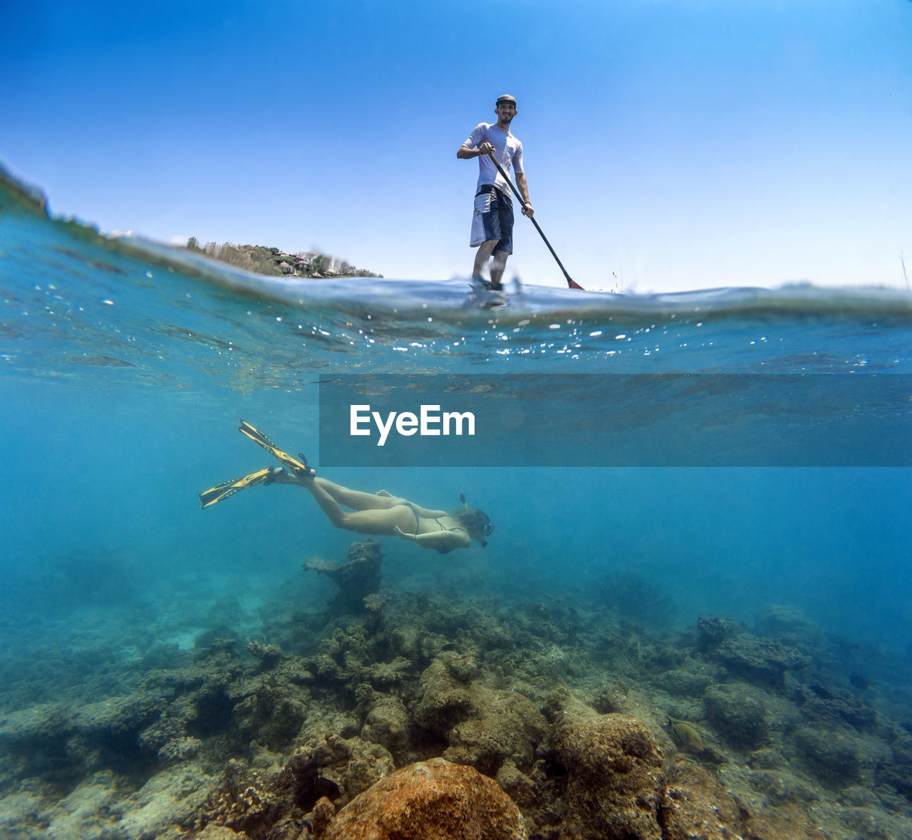 Young couple have a fun in ocean water, underwater view