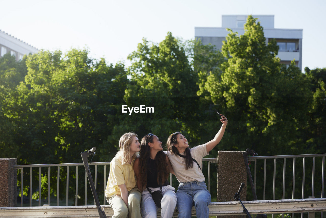 Group of young female friends taking selfie outdoors