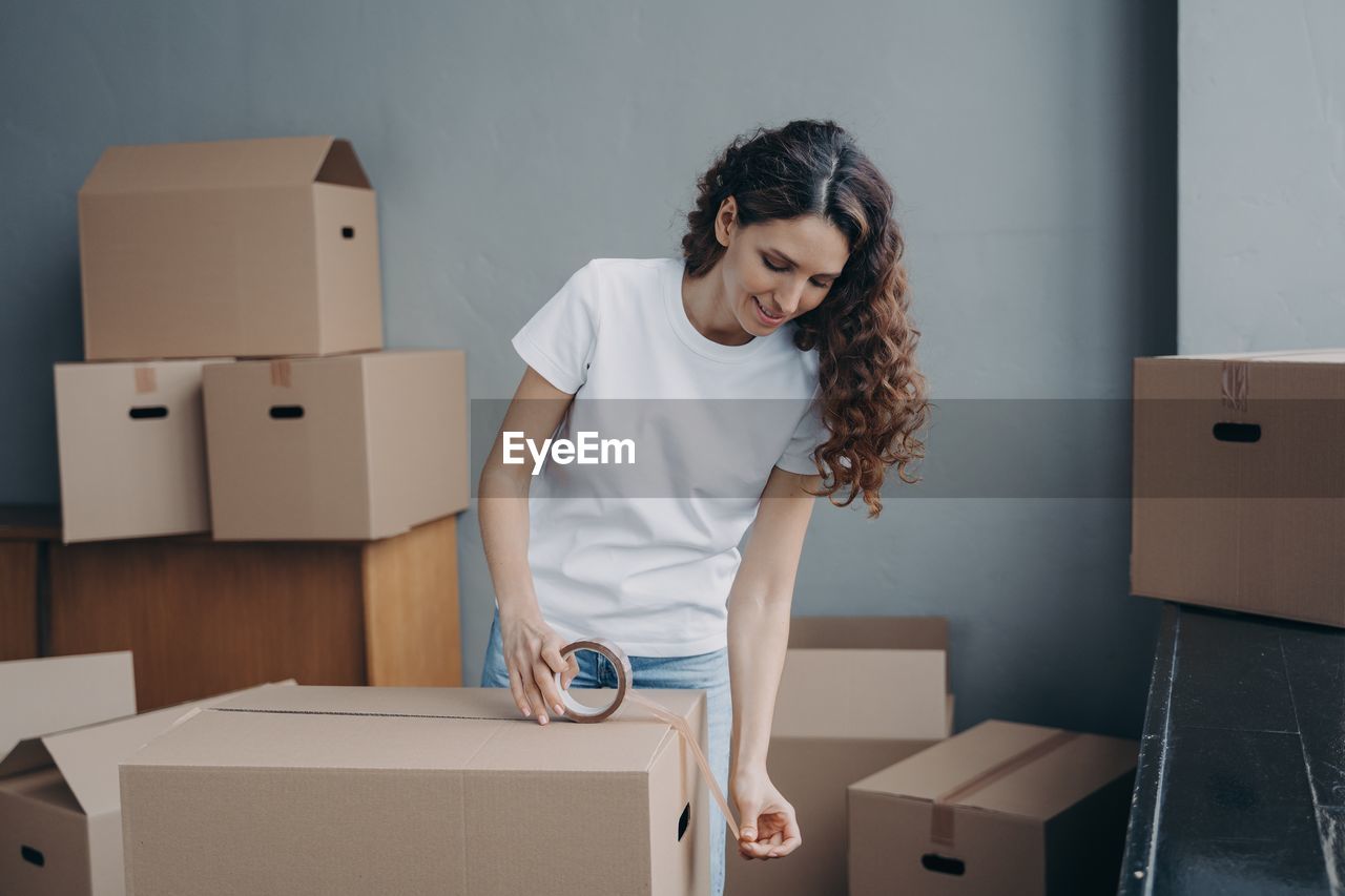 side view of young woman working in box