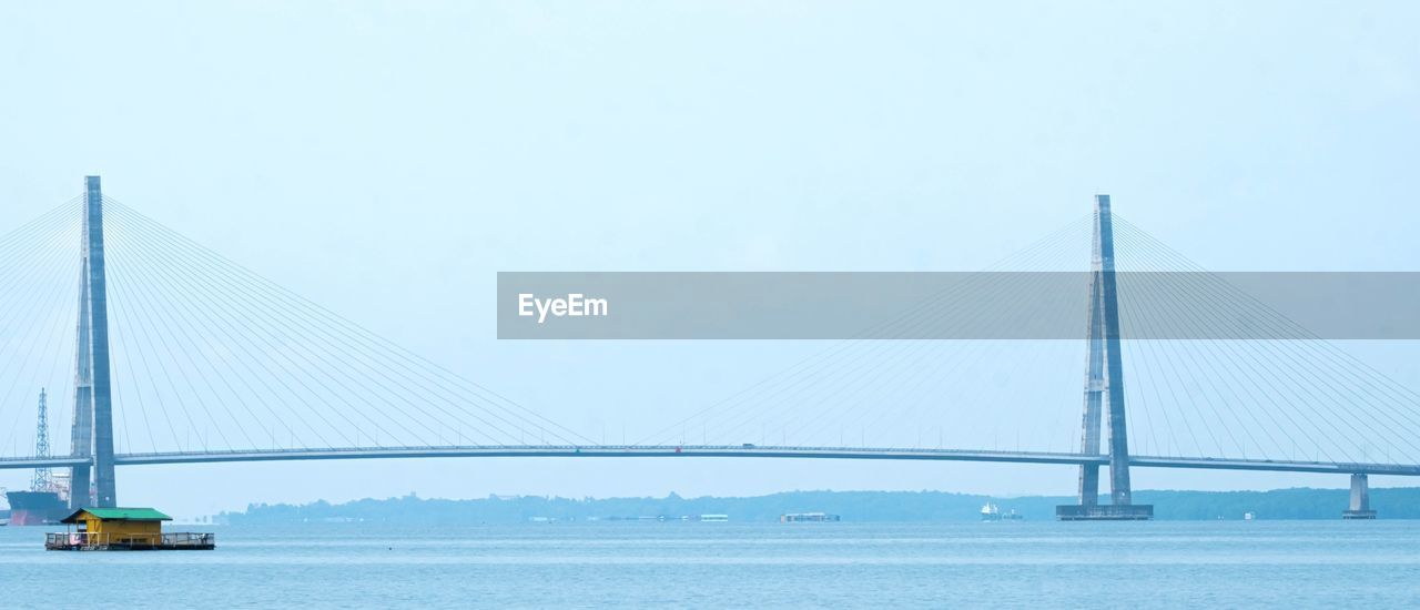 bridge, transportation, suspension bridge, cable-stayed bridge, water, architecture, built structure, sky, travel destinations, engineering, travel, nature, sea, copy space, tourism, city, blue, mode of transportation, panoramic, beauty in nature, bay, day, clear sky, outdoors, nautical vessel, scenics - nature, bay of water, environment, landscape, tranquility, motor vehicle, car, road, cityscape, tranquil scene, building exterior, horizon, urban skyline, cable