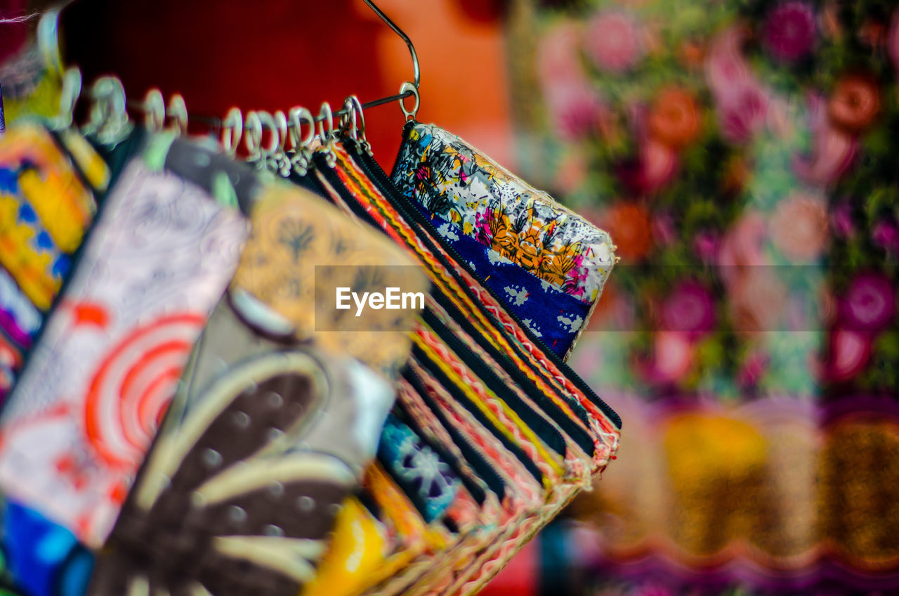 Close-up of colorful pouches at market for sale