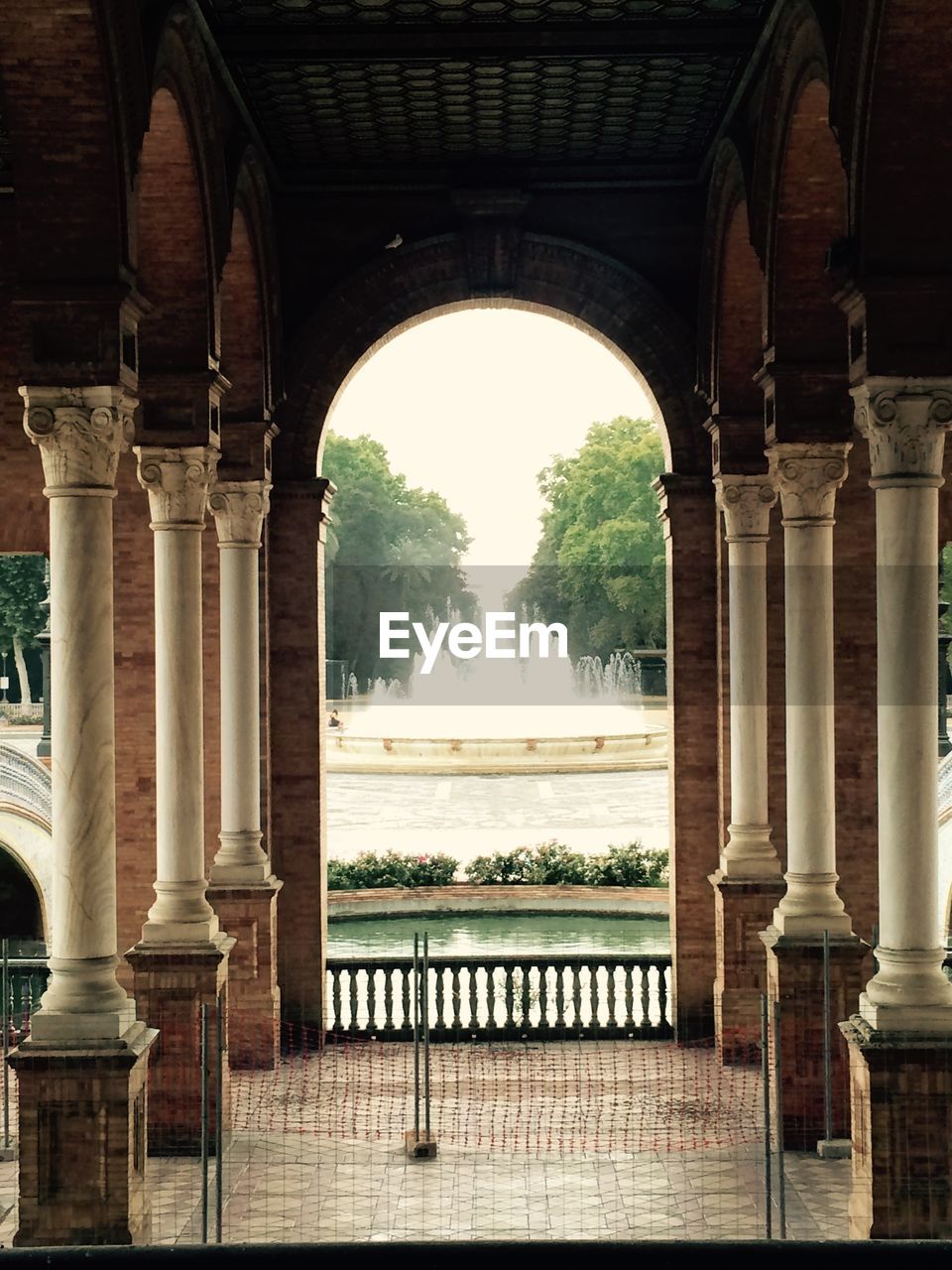 Water fountain seen through built structure in park