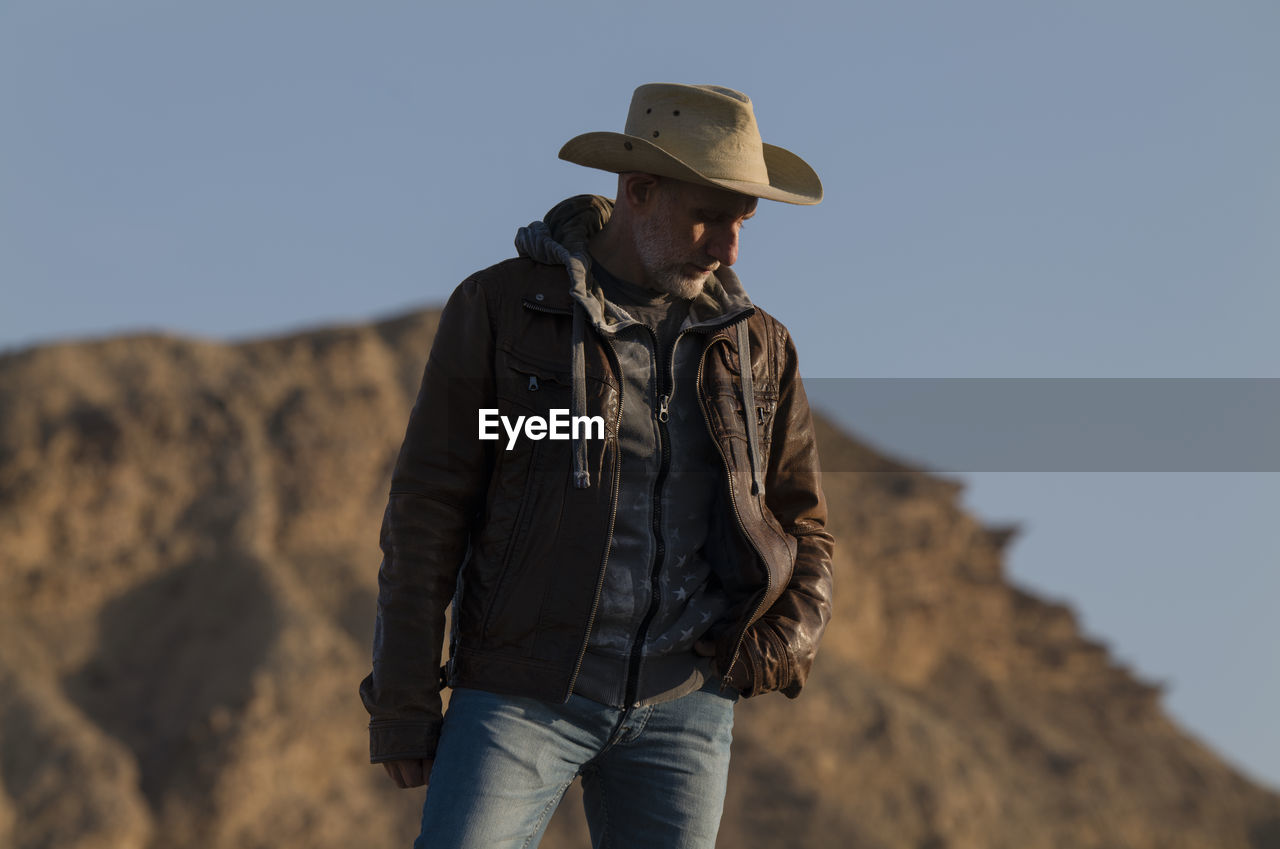 Adult man in cowboy hat in tabernas desert, almeria, spain