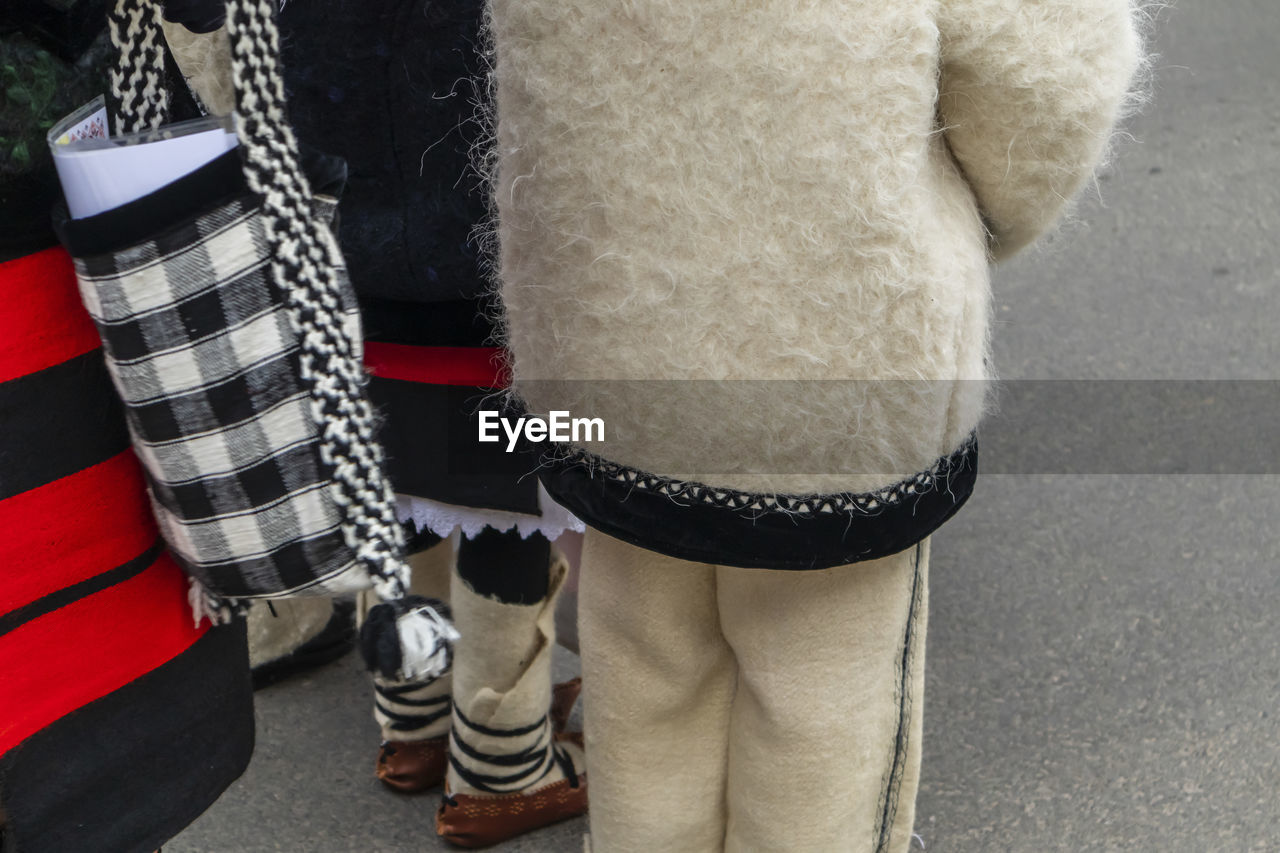 Rear view of people in warm clothing standing on street