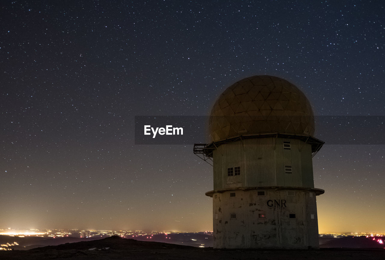 Built structure against starry sky at night