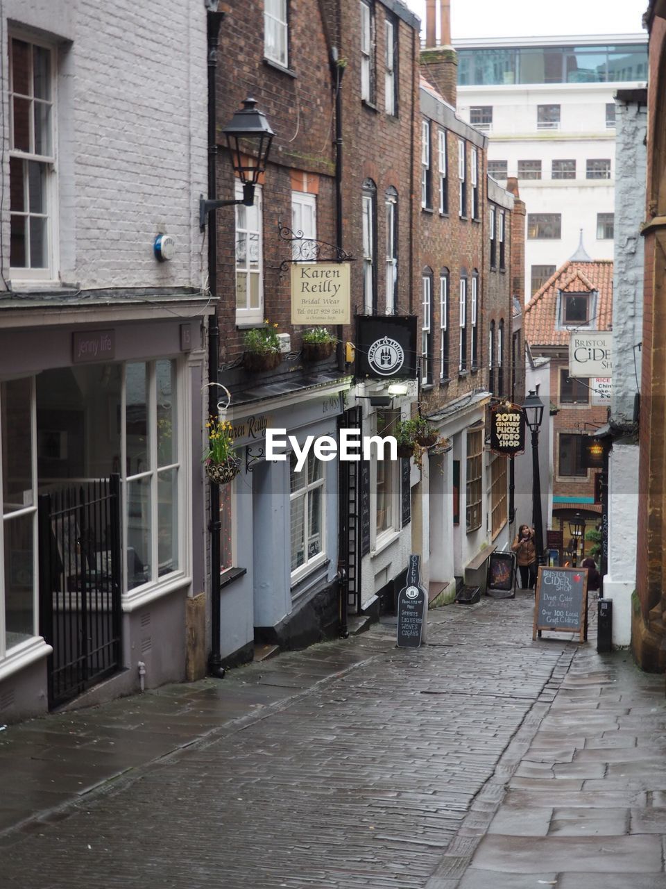 NARROW ALLEY WITH BUILDINGS IN BACKGROUND