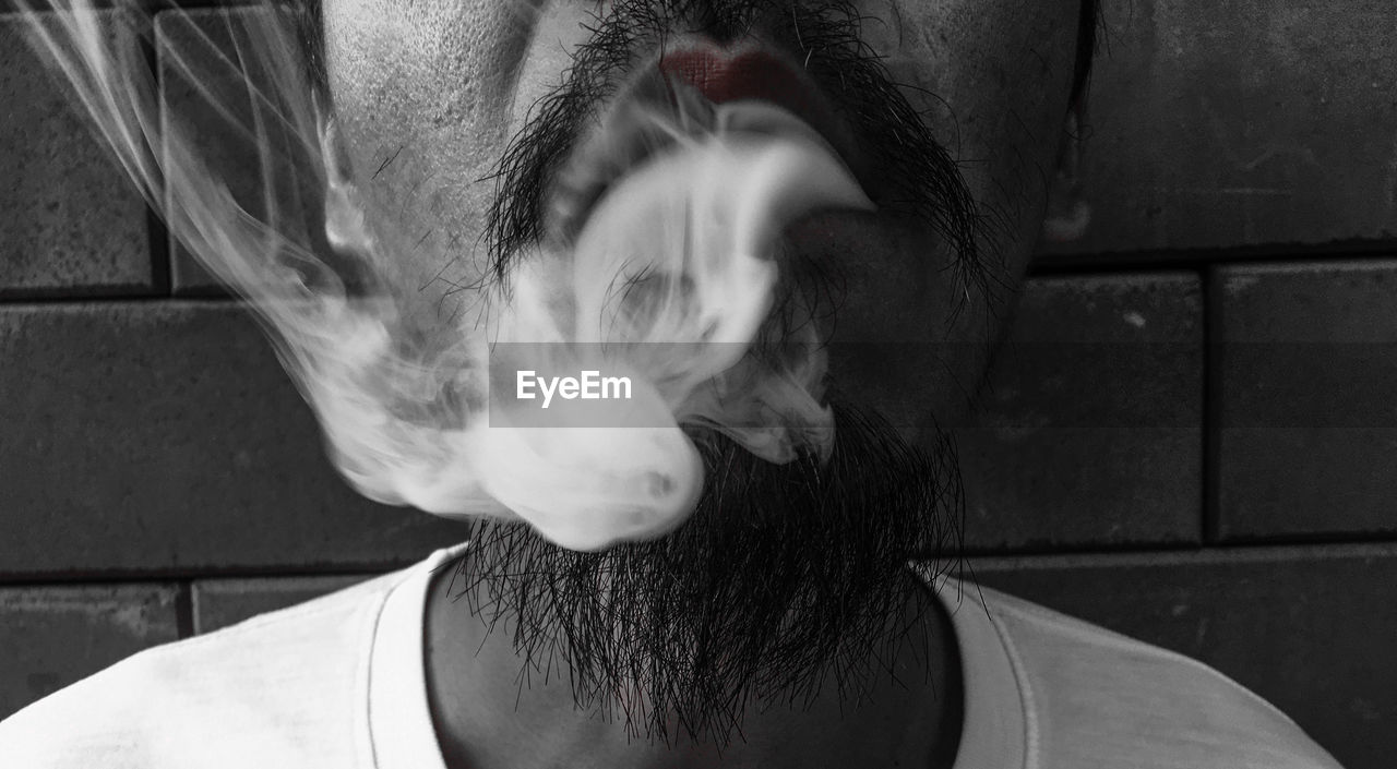 Close-up of man exhaling smoke