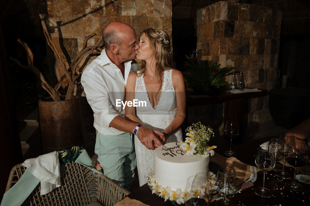 Midsection of man and woman standing on table