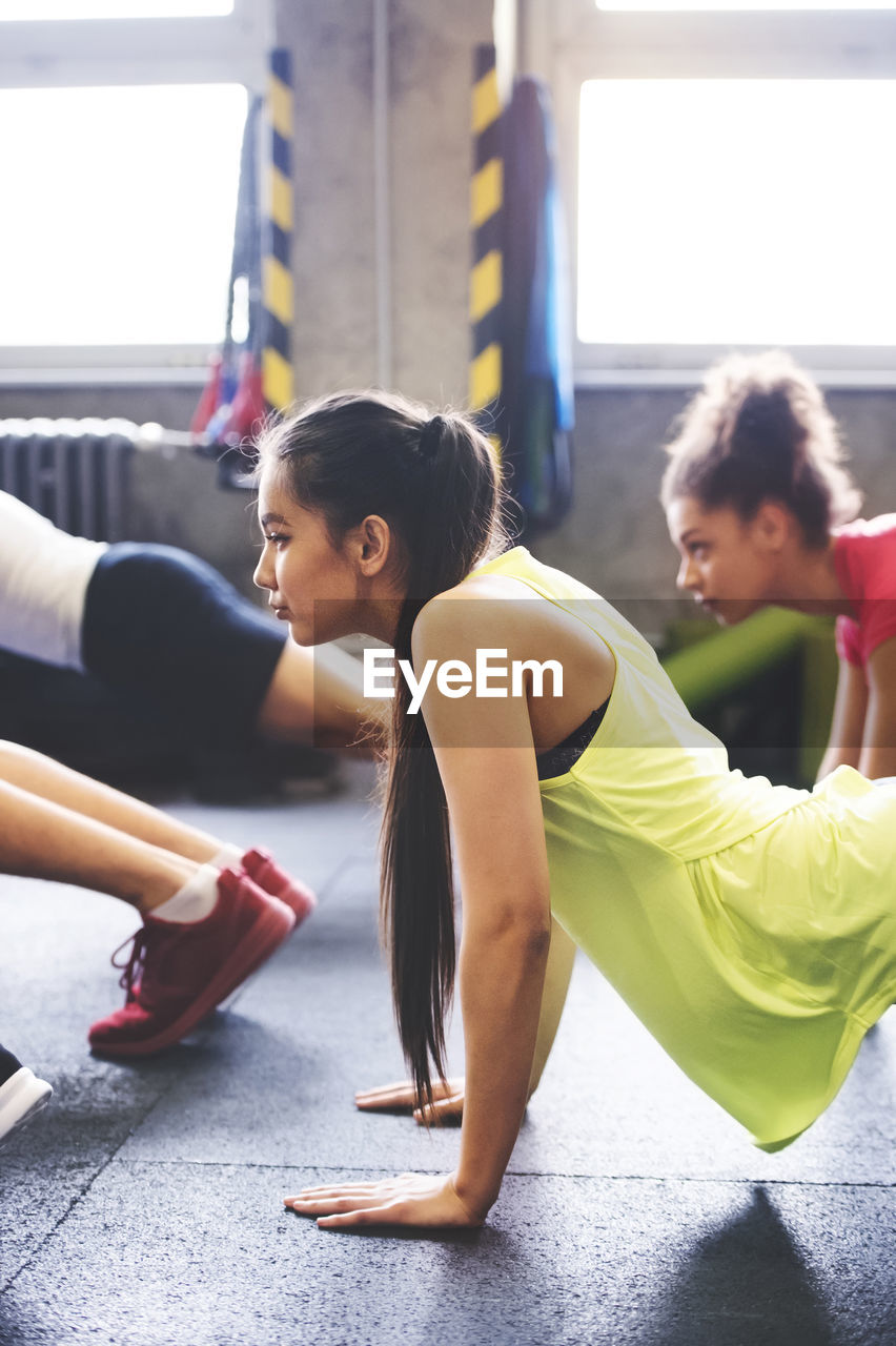 Group of young people exercising in gym