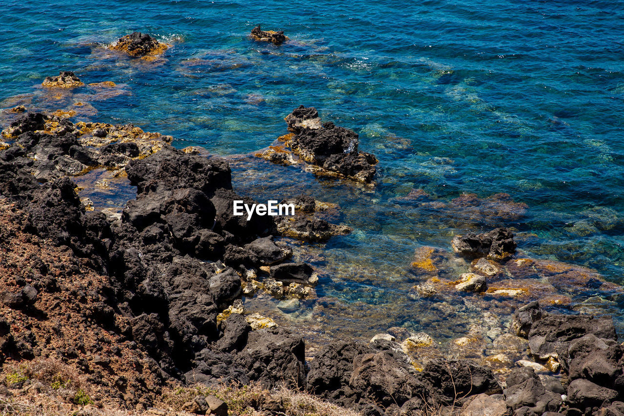 Detail of the rocks on the famous red beach at santorini island in a beautiful early spring day