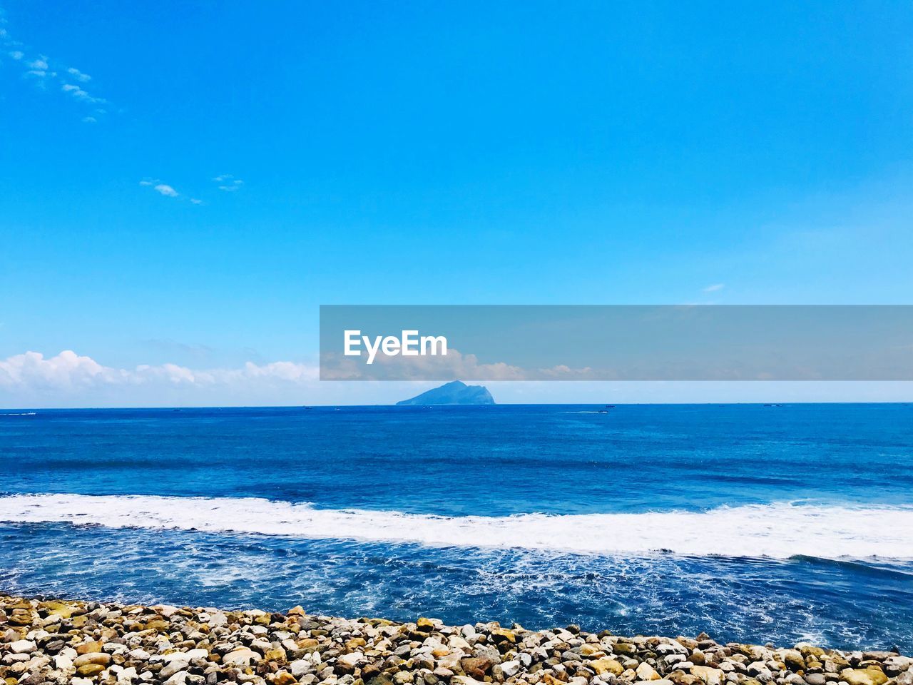 Scenic view of sea against blue sky