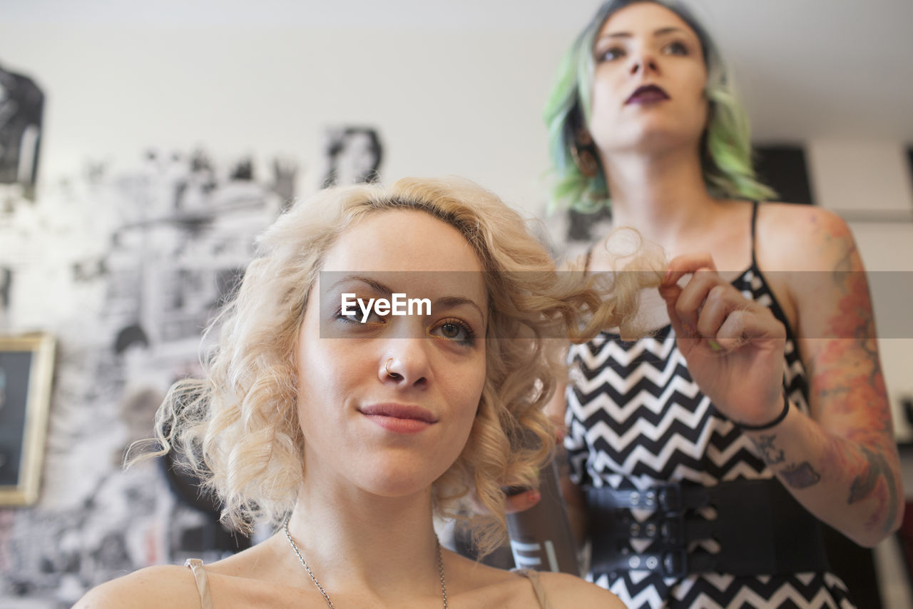 A hair dresser styling a customer's hair.