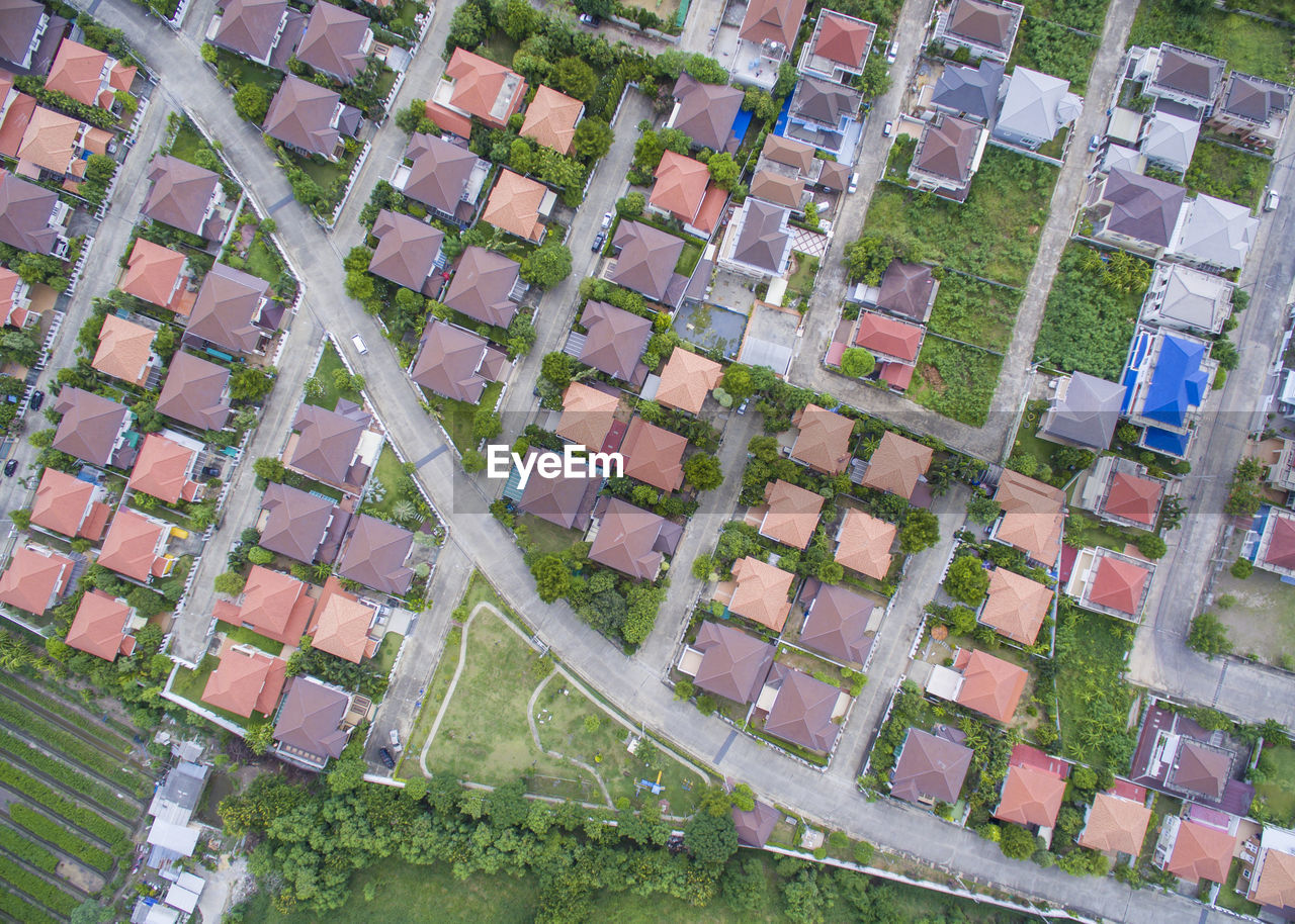 High angle view of road amidst houses on field