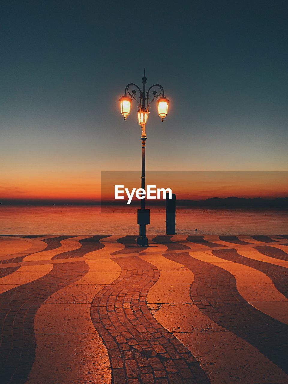 STREET LIGHTS ON BEACH AT SUNSET