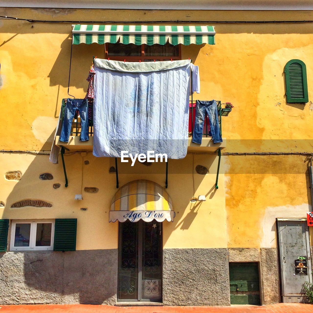 Low angle view of building with clothes line at balcony