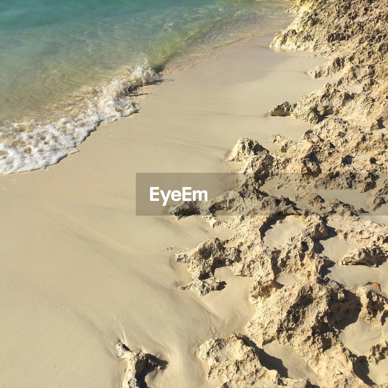 High angle view of sandy beach on sunny day