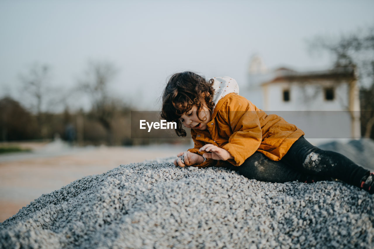 Side view of child playing outdoors