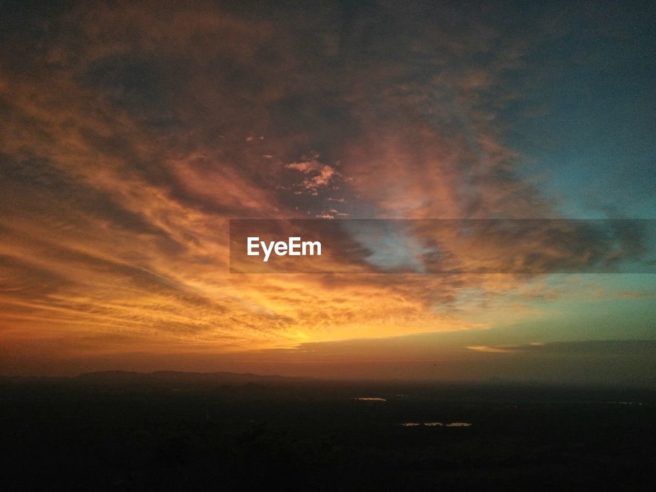 SCENIC VIEW OF SUNSET OVER SEA