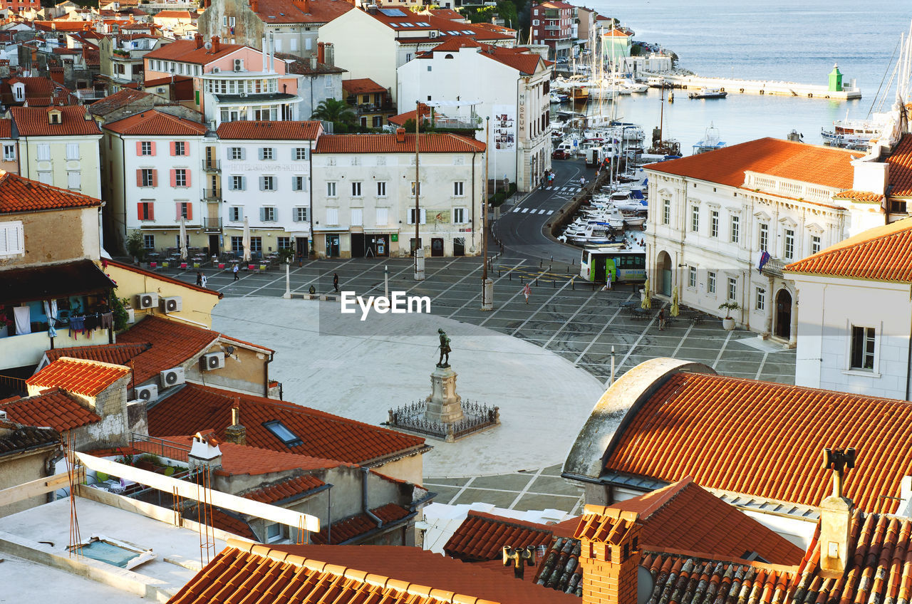 Red roofs of old town piran with main church against the sunrise sky, adriatic sea. slovenia