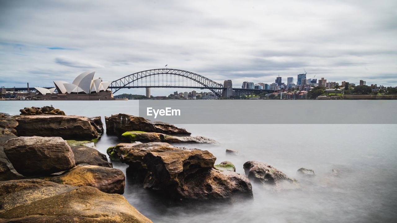 Bridge over river with city in background