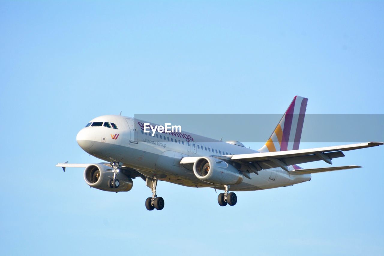 AIRPLANE FLYING AGAINST SKY