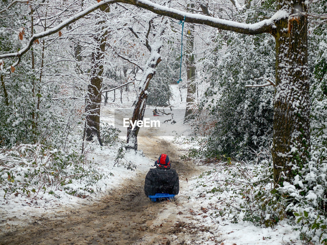 REAR VIEW OF PERSON ON SNOW COVERED MOUNTAIN