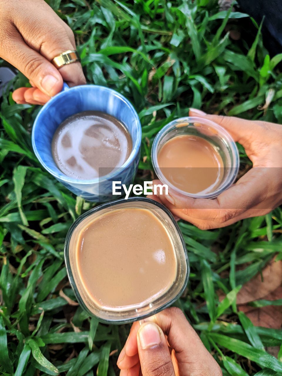 Cropped hand of woman and men holding tea which is called best therapeutic 