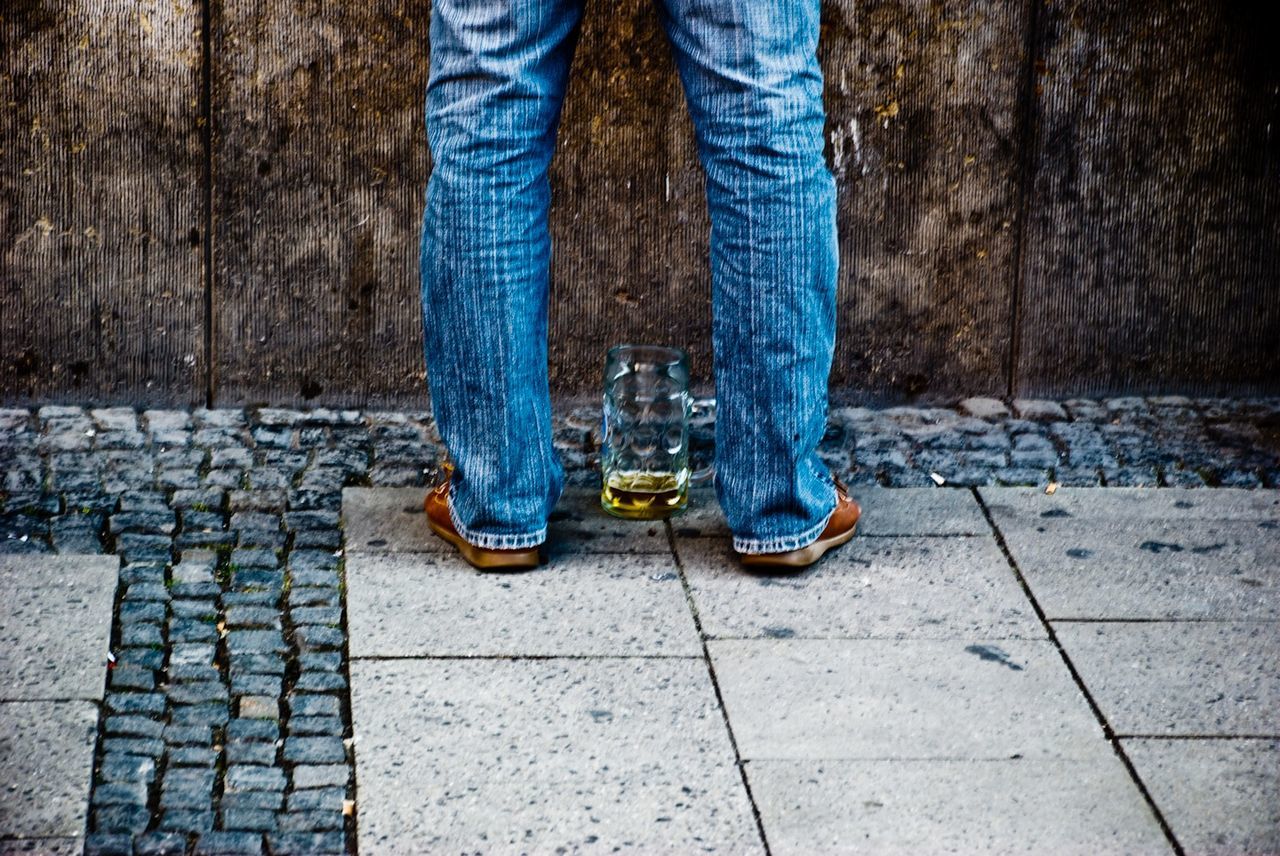 Low section of man standing on footpath