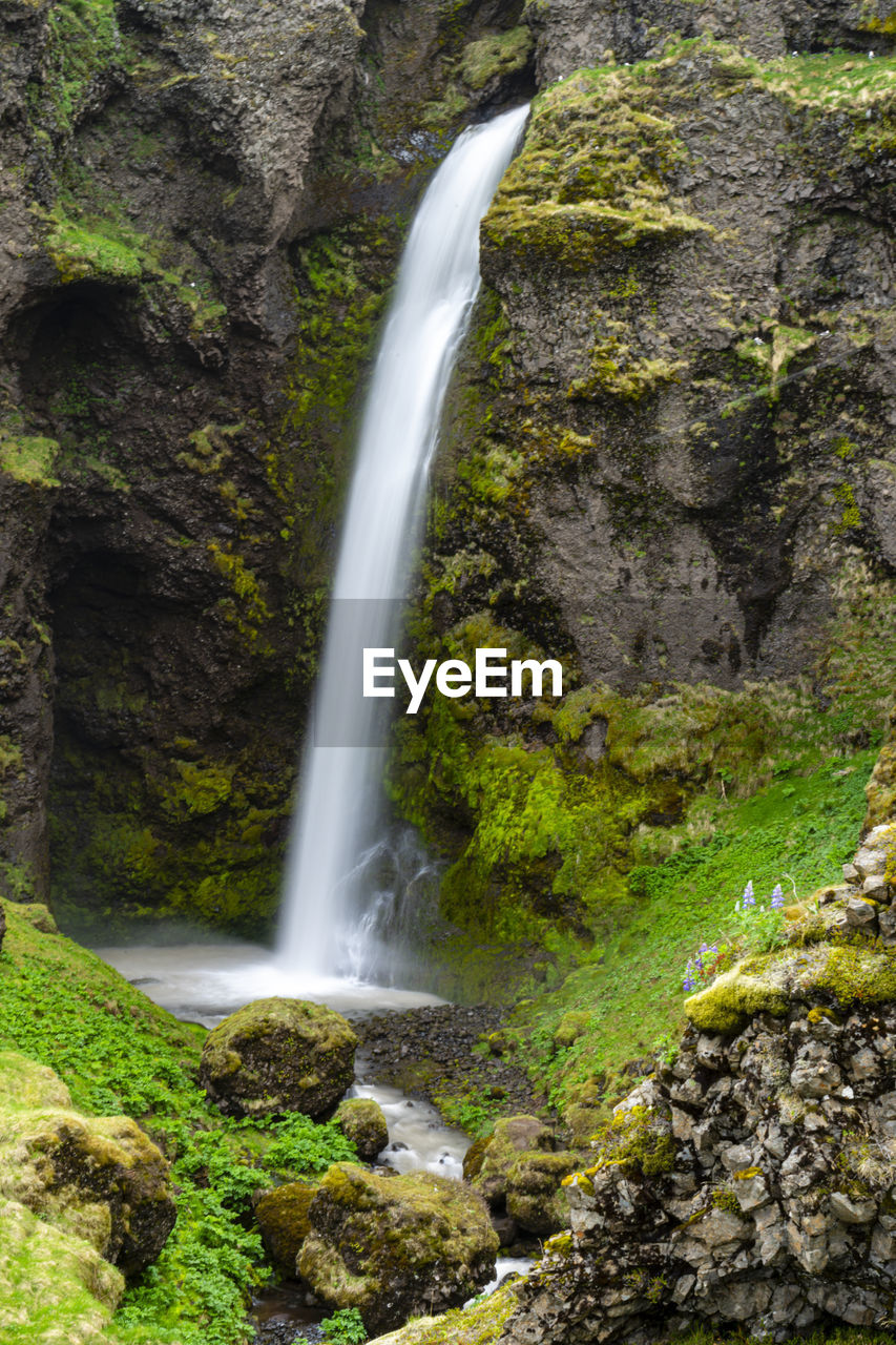 waterfall, beauty in nature, water, scenics - nature, rock, motion, long exposure, nature, land, flowing water, plant, environment, forest, body of water, tree, moss, water feature, blurred motion, stream, no people, rock formation, non-urban scene, flowing, green, outdoors, power in nature, watercourse, travel destinations, day, splashing, autumn, idyllic, cliff, sports, travel, landscape, speed