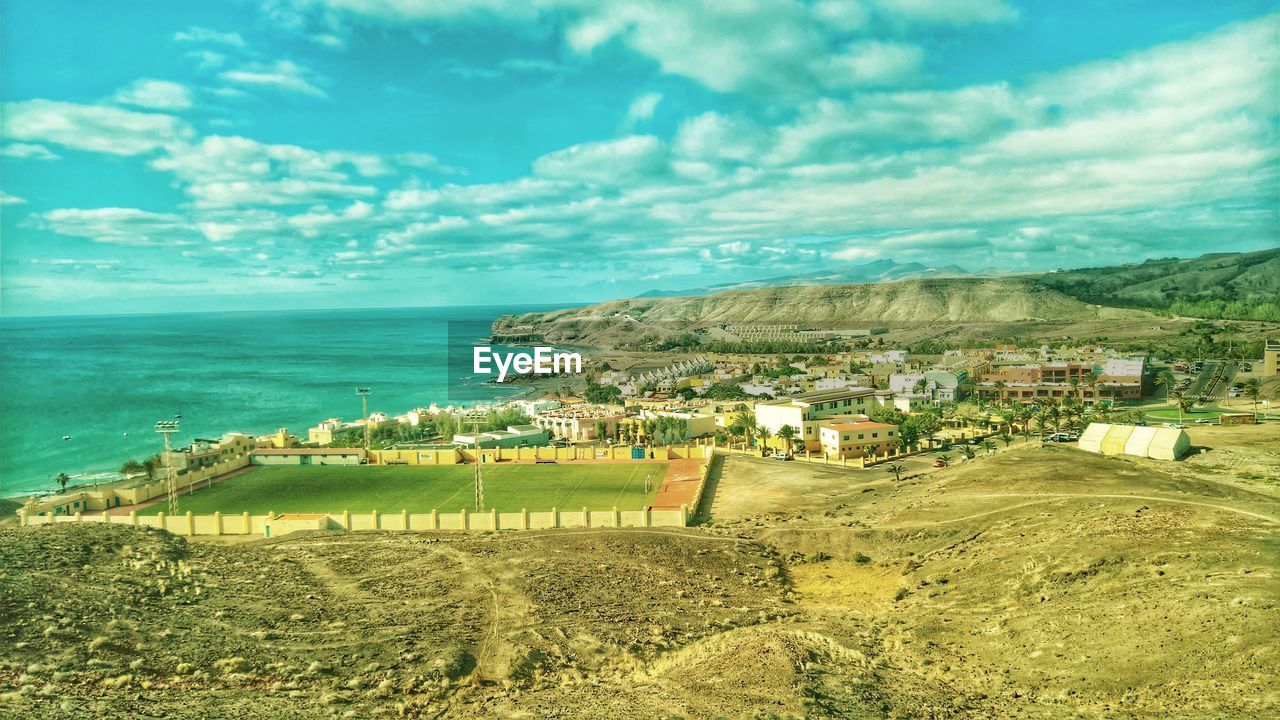 Scenic view of sea and buildings against sky