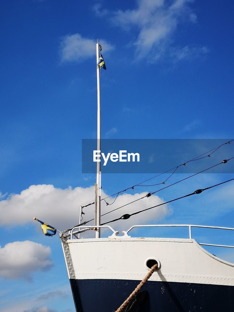 Low angle view of sailboat against blue sky