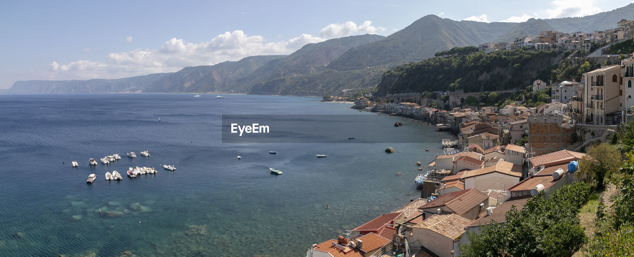 High angle view of sea and buildings against sky